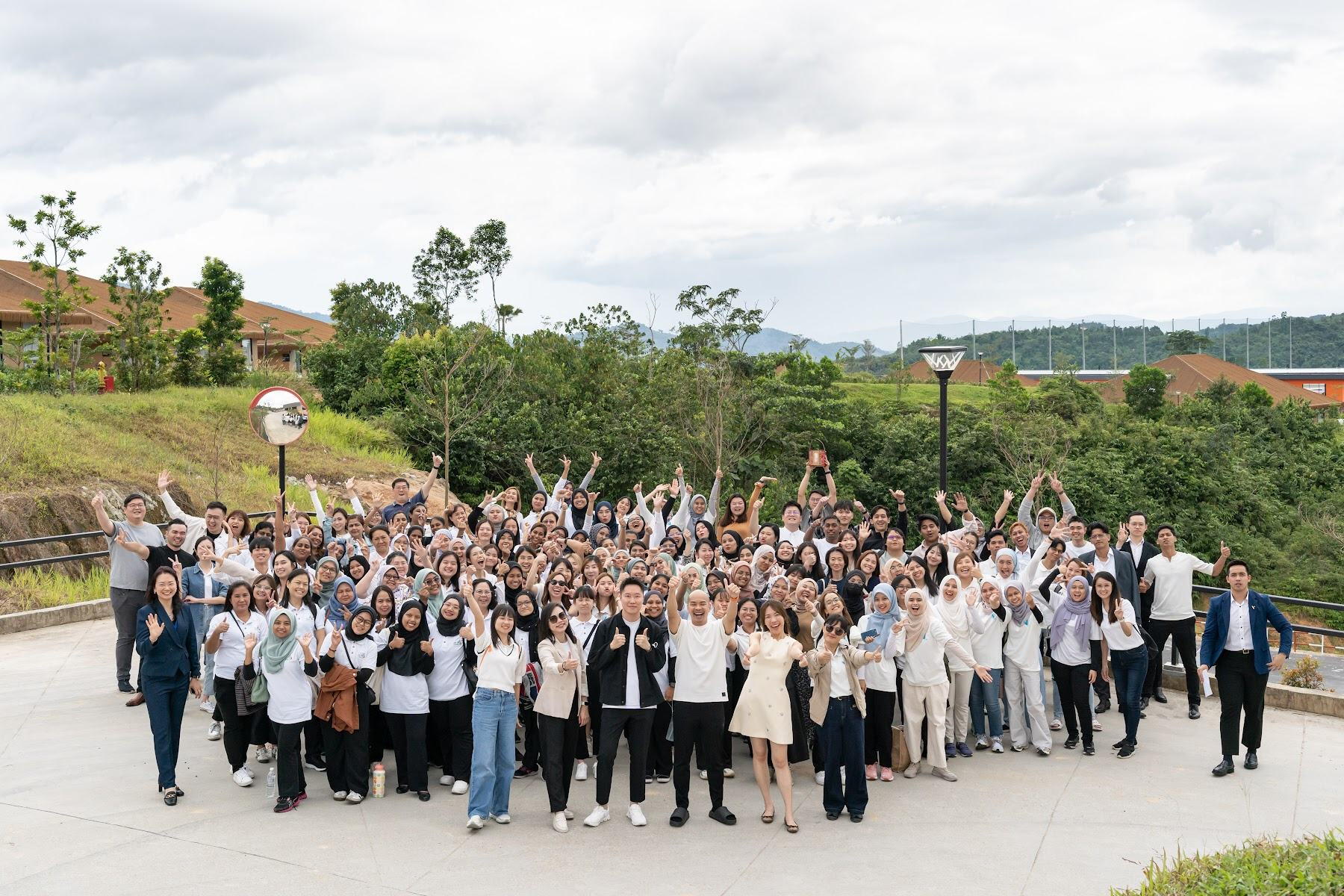 Full company outdoor group photo at an AZEO annual event in Malaysia