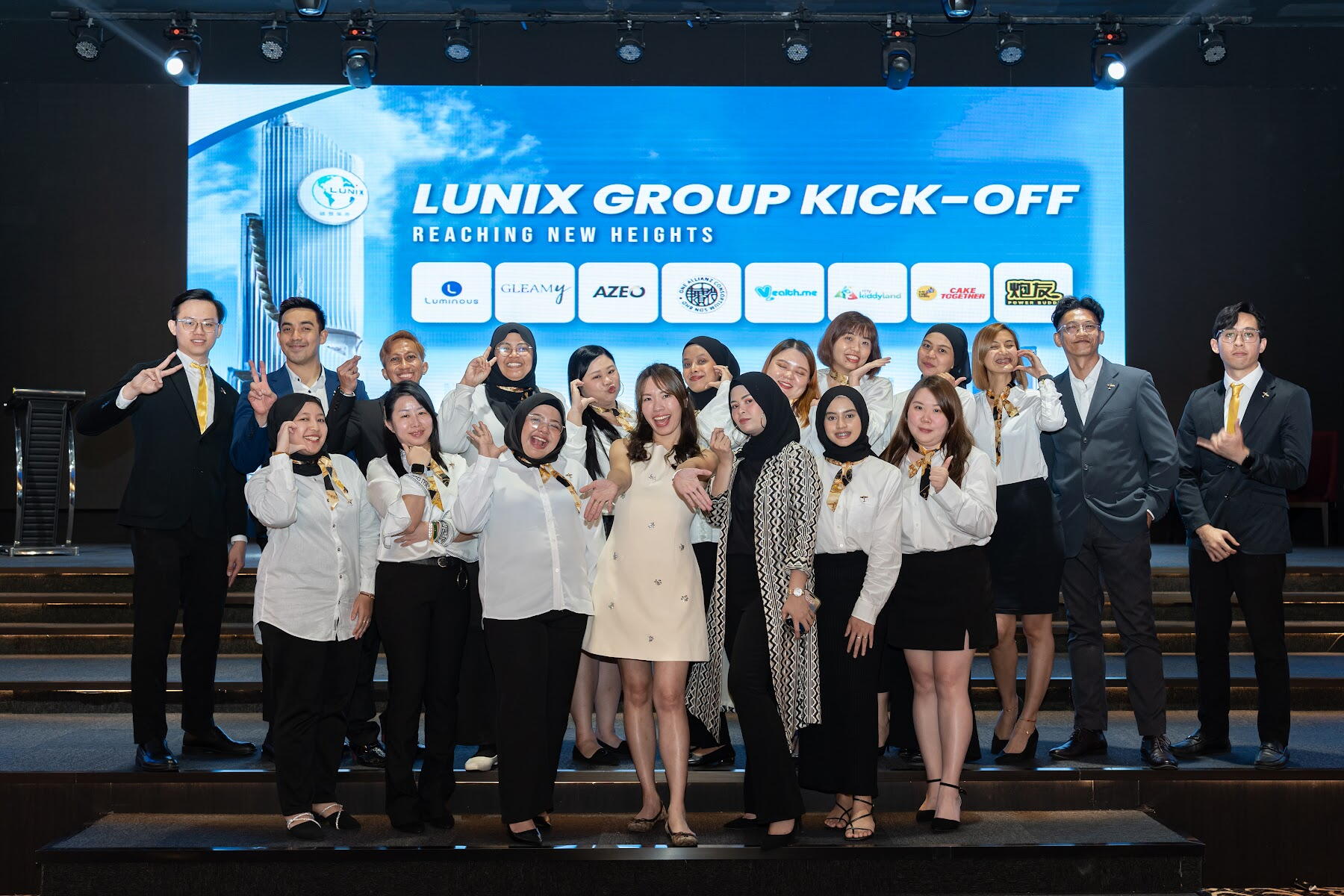 Group on stage at an AZEO annual kick-off event