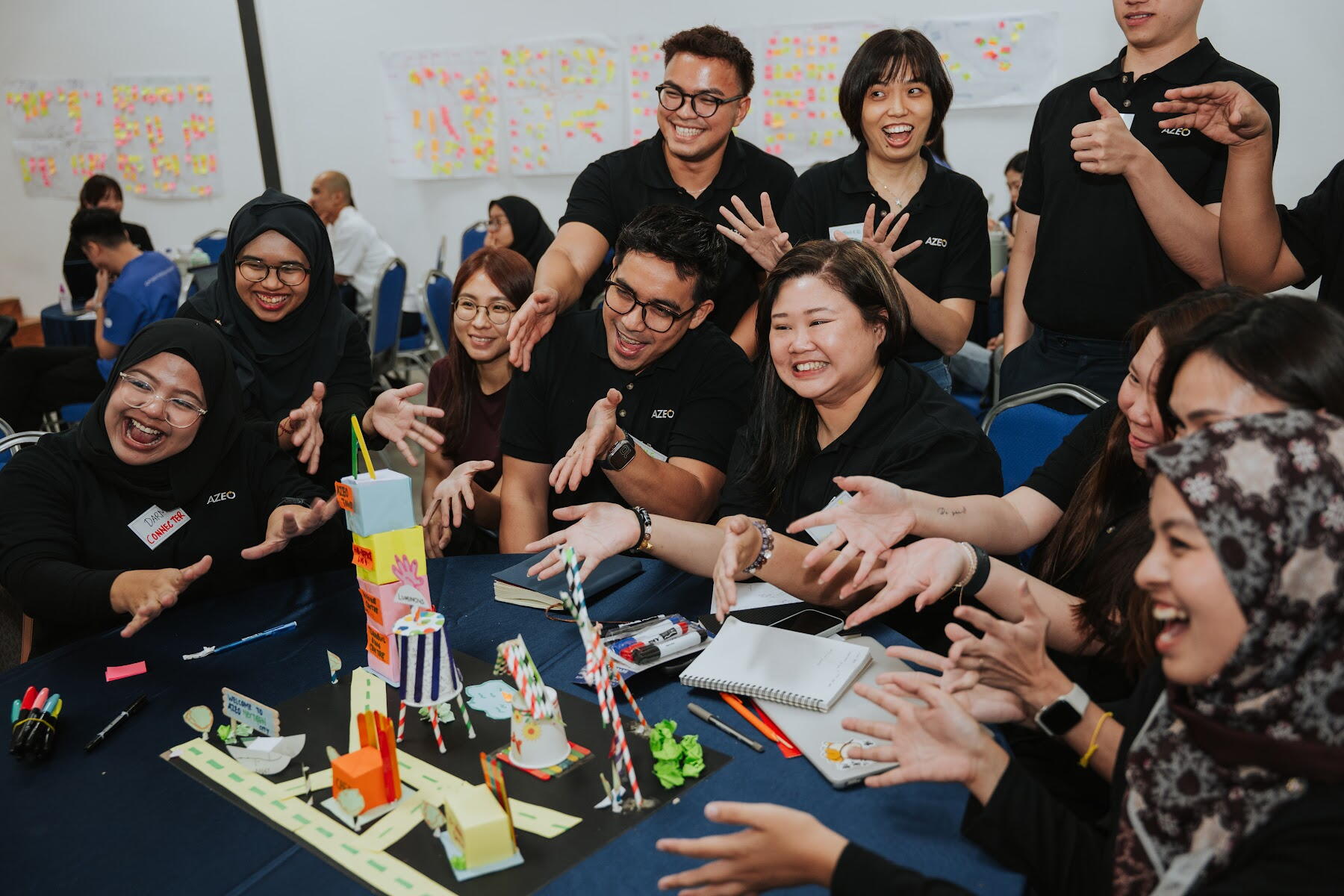 Hands-on team challenge built at a table during a facilitated session