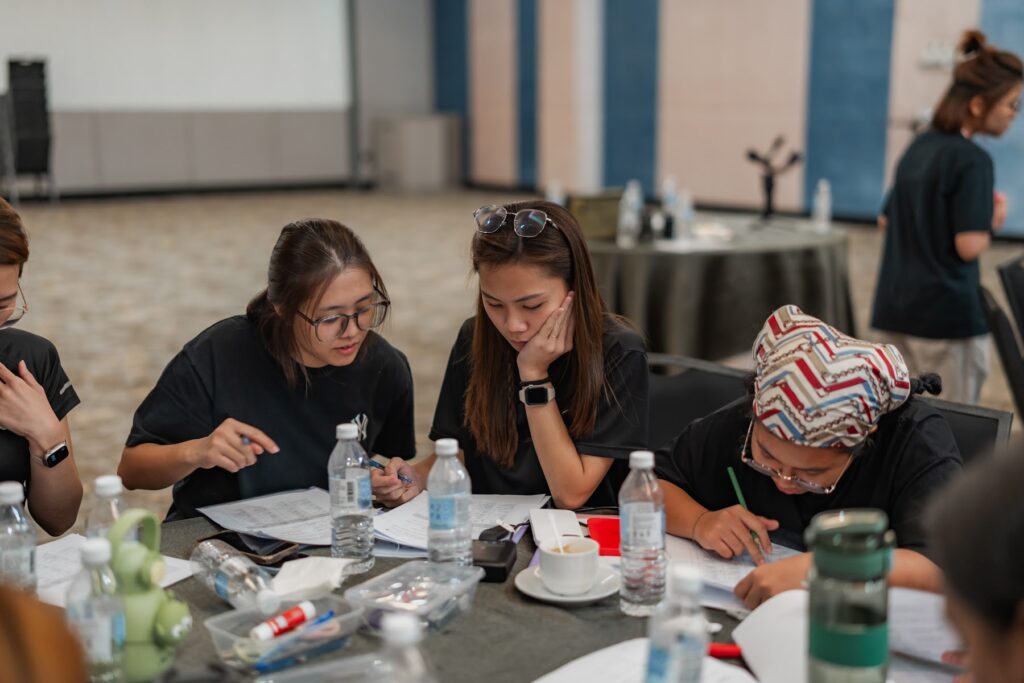 Participants taking notes during an AZEO training session