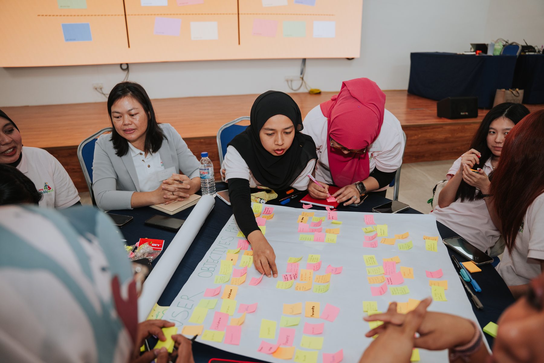 Participants working through a hands-on group exercise at an AZEO workshop