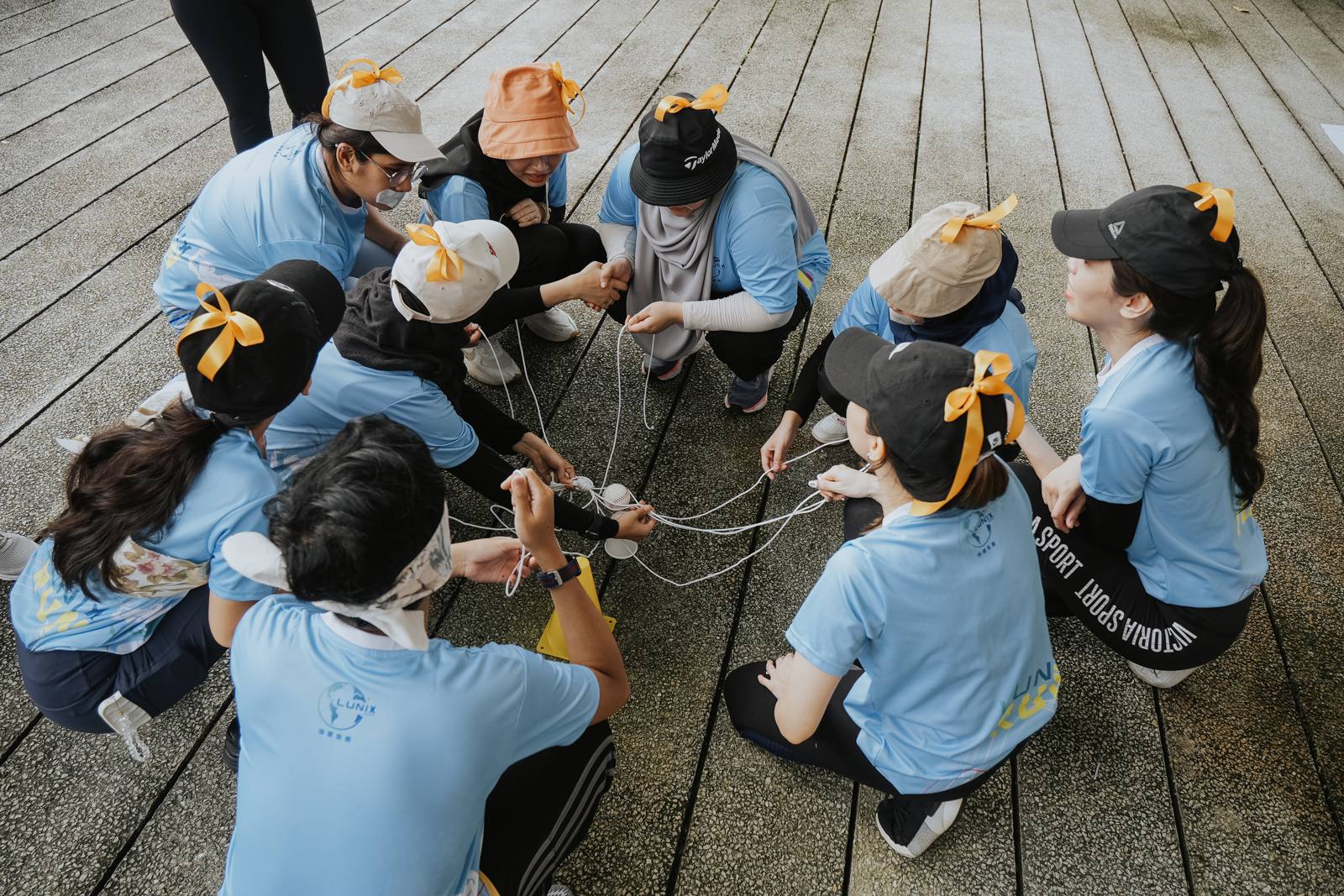 A team working together on a rope challenge during an AZEO team building programme